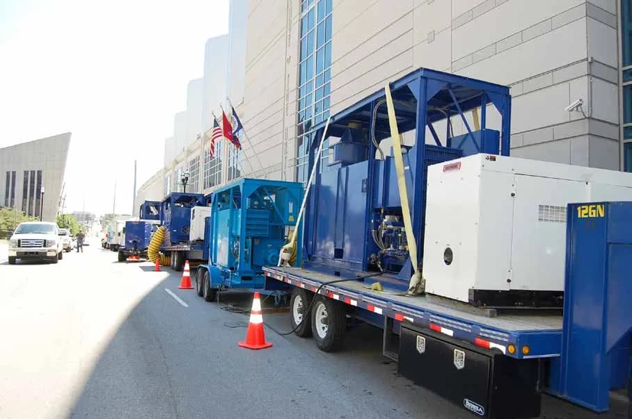 Drying and power equipment outside an arena after a major rain event
