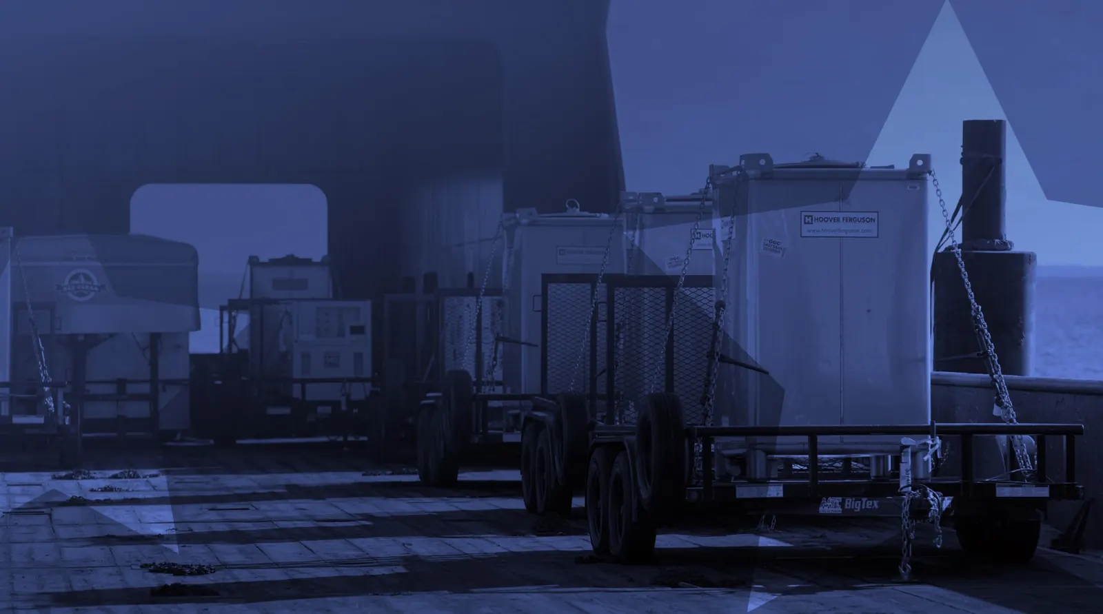 ALL CLEAR trailers and equipment chained down on a ship's deck