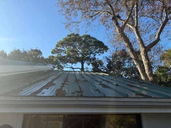 A long metal roof edge with an undersized gutter