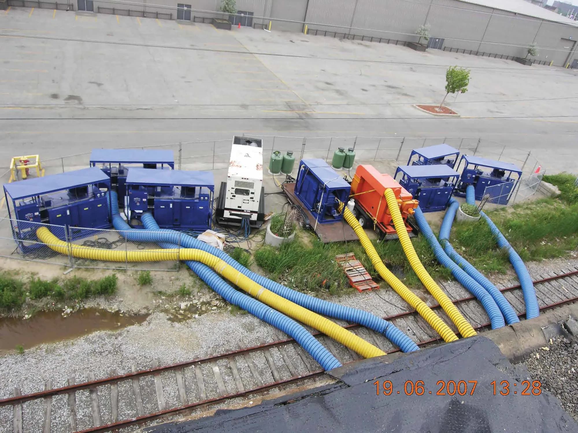 Trailer-mounted desiccant dehumidifiers feeding ducting into a building
