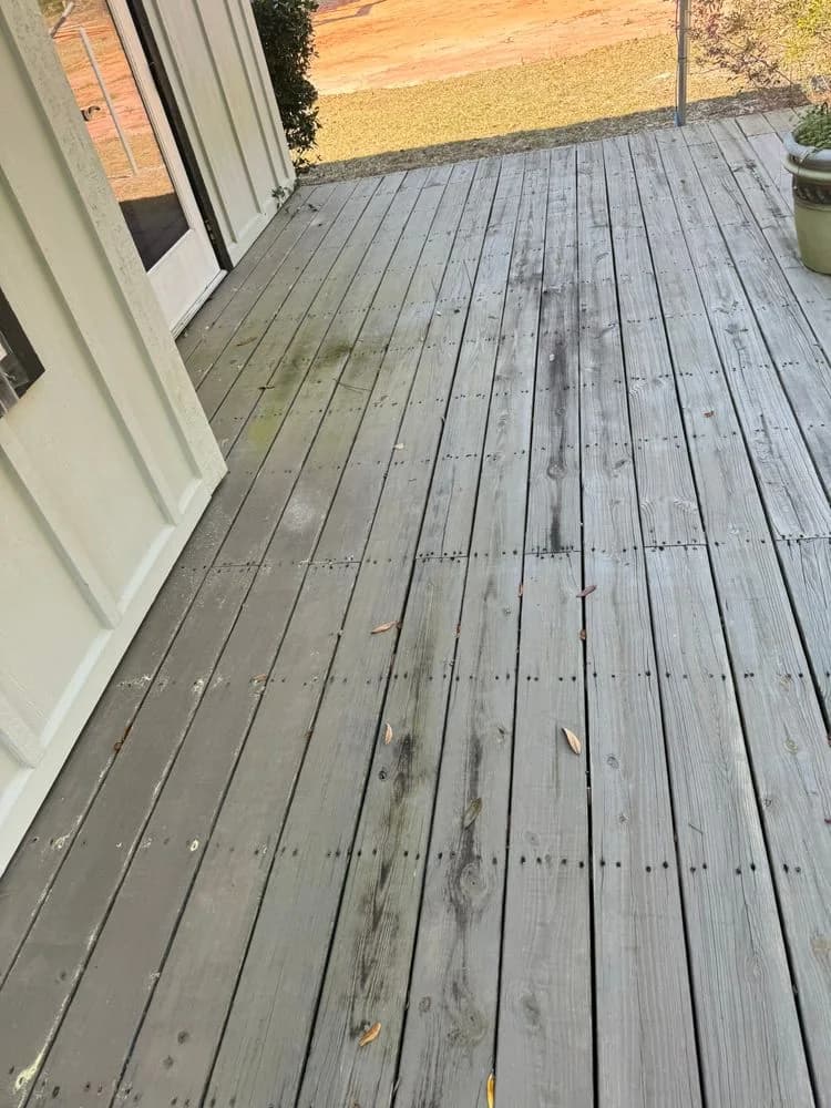 Weathered deck boards next to the house wall