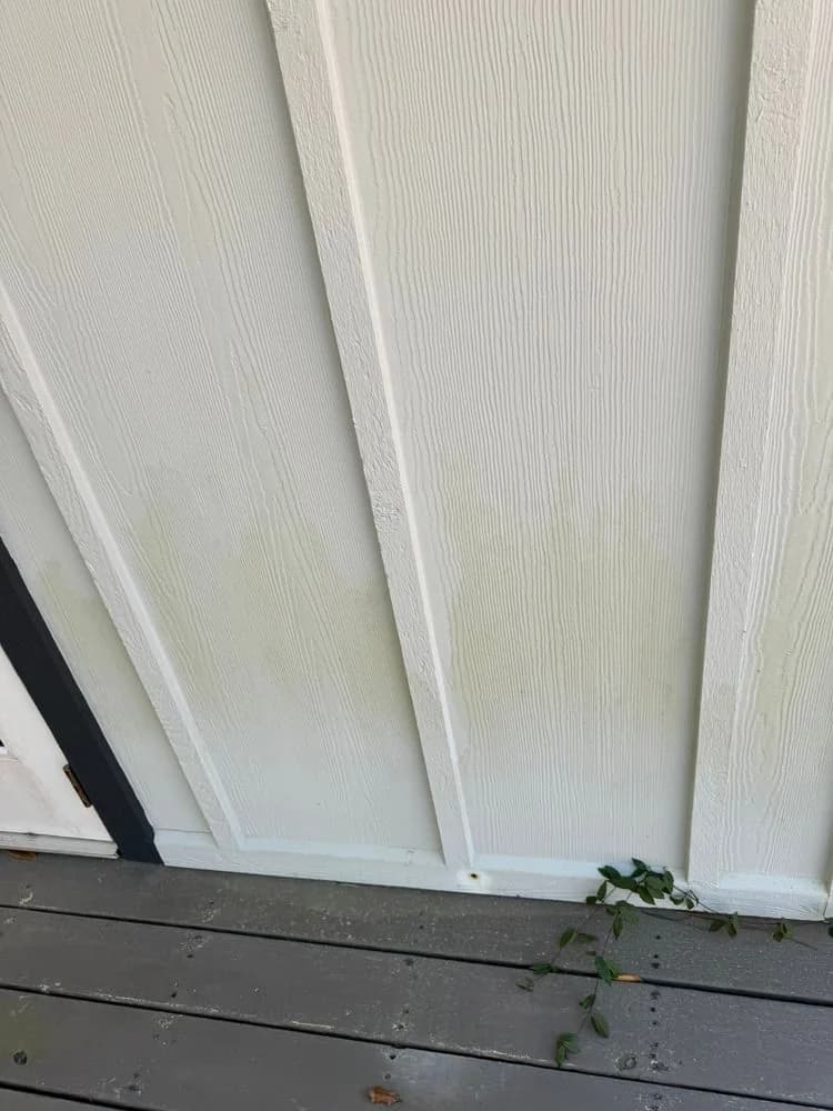 Board-and-batten siding with staining near the bottom